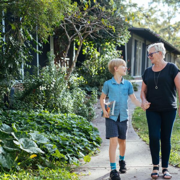 Women and boy walking from library