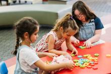 Young girls playing with puzzle pieces
